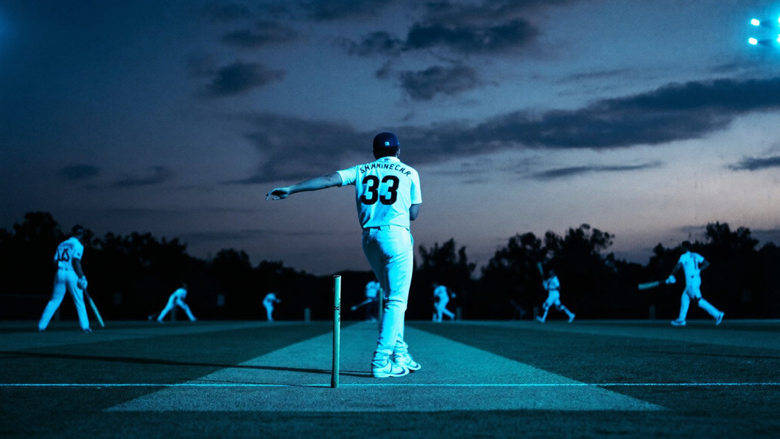 Batsman driving through the line in an afternoon cricket match